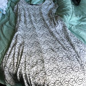 Flair cut white dress with black leaf embroidery.